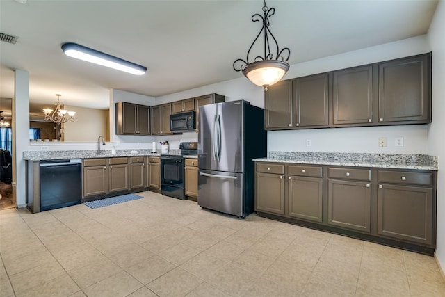 1224 Evergreen St, Royse City, TX 75189 - kitchen featuring black appliances, a chandelier, decorative light fixtures, a sink, and light stone counters