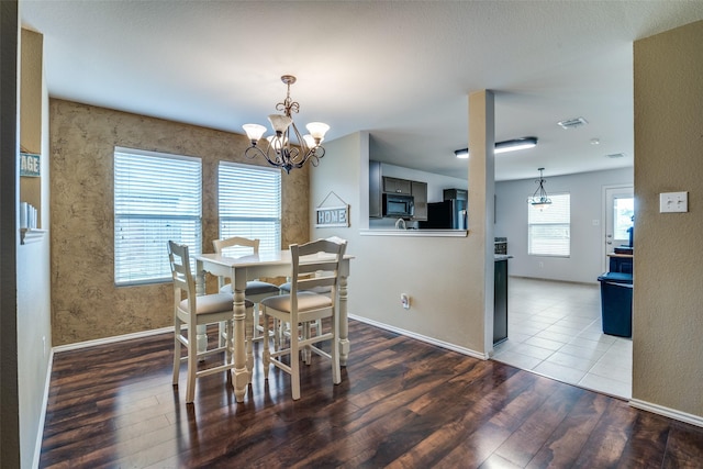 1224 Evergreen St, Royse City, TX 75189 - dining space with wood finished floors, a chandelier, and baseboards