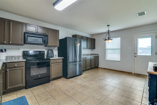 1224 Evergreen St, Royse City, TX 75189 - kitchen with black appliances, light tile patterned floors, pendant lighting, baseboards, and light stone countertops