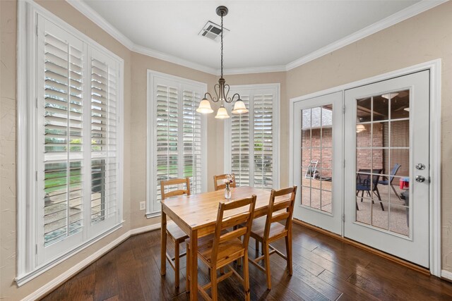 9205 Yellow Stone Rd, Waco, TX 76712 - dining space with dark wood finished floors, ornamental molding, a chandelier, and healthy amount of natural light