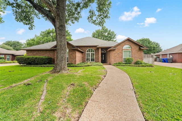9205 Yellow Stone Rd, Waco, TX 76712 - single story home featuring brick siding, roof with shingles, and a front lawn