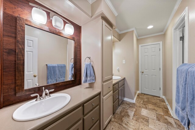 9205 Yellow Stone Rd, Waco, TX 76712 - bathroom with crown molding, baseboards, stone tile flooring, two vanities, and recessed lighting