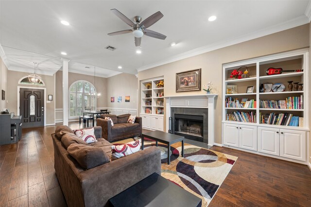 9205 Yellow Stone Rd, Waco, TX 76712 - living area featuring built in shelves, ornamental molding, a fireplace with flush hearth, a ceiling fan, and dark wood-type flooring