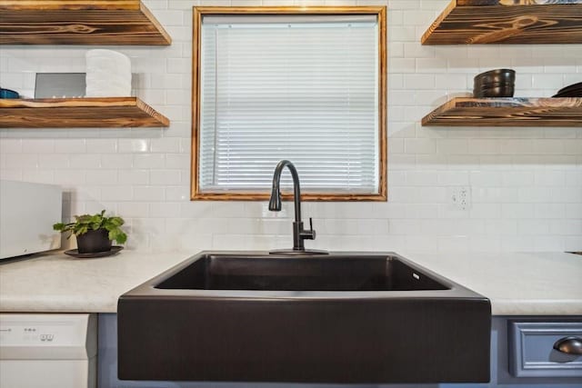 1004 Fairway Ln, Mexia, TX 76667 - kitchen with a sink, tasteful backsplash, white dishwasher, and light countertops