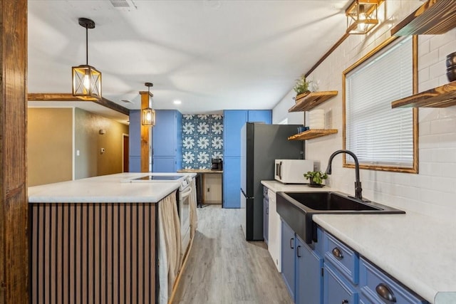 1004 Fairway Ln, Mexia, TX 76667 - kitchen with blue cabinets, open shelves, a sink, white appliances, and light wood-style floors