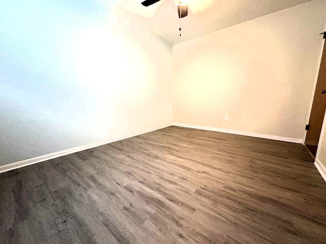 1004 Fairway Ln, Mexia, TX 76667 - spare room with dark wood-type flooring, a ceiling fan, and baseboards