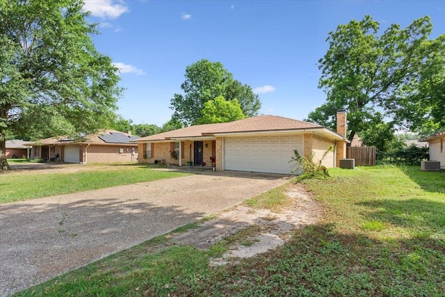 1004 Fairway Ln, Mexia, TX 76667 - ranch-style house featuring a garage, concrete driveway, a chimney, central AC, and brick siding