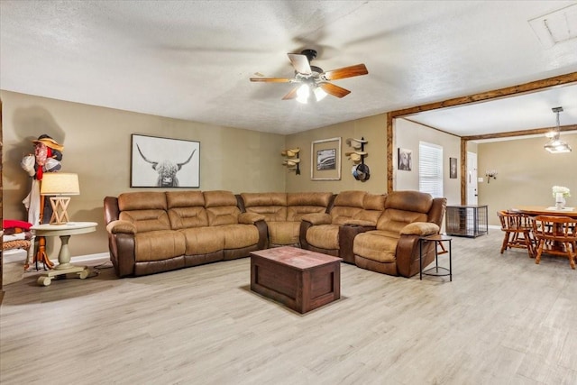 1004 Fairway Ln, Mexia, TX 76667 - living area featuring light wood finished floors, ceiling fan, baseboards, and a textured ceiling