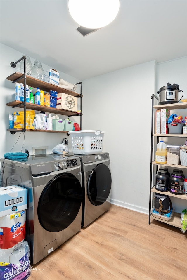 2147 Pine Hill Rd, Shreveport, LA 71107 - laundry area with separate washer and dryer, wood finished floors, and baseboards