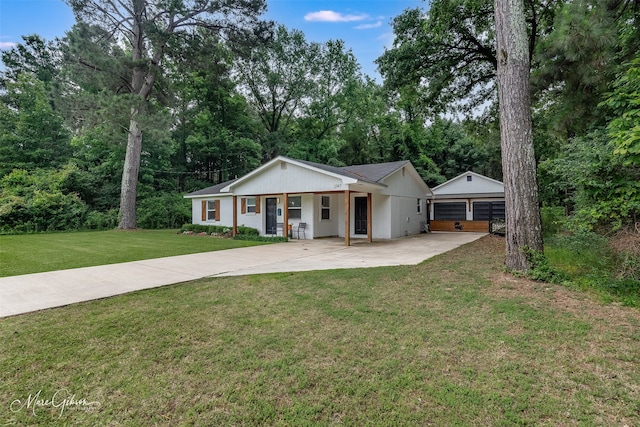 2147 Pine Hill Rd, Shreveport, LA 71107 - view of front of property with concrete driveway, a front yard, an outbuilding, and view of wooded area