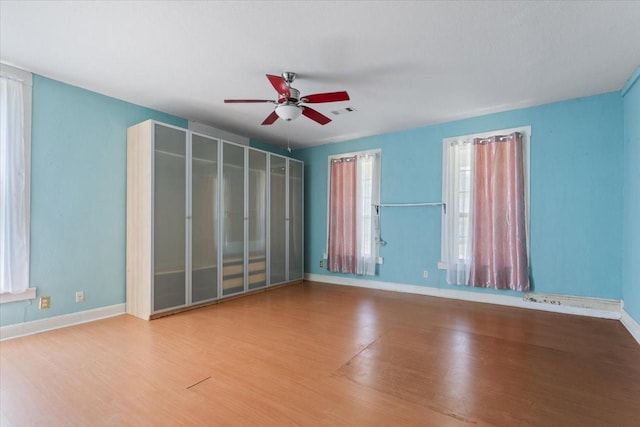 413 Houghton Ave, Marlin, TX 76661 - empty room with ceiling fan, wood finished floors, and baseboards