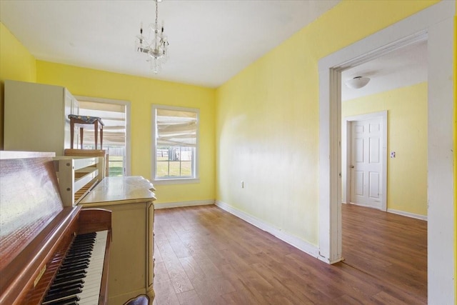 413 Houghton Ave, Marlin, TX 76661 - unfurnished office featuring wood finished floors, baseboards, and a chandelier
