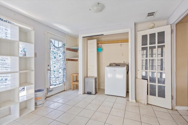 413 Houghton Ave, Marlin, TX 76661 - laundry area featuring washer / clothes dryer and light tile patterned floors