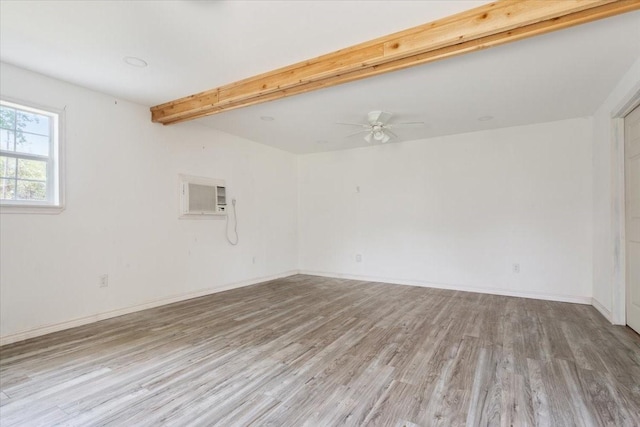 413 Houghton Ave, Marlin, TX 76661 - unfurnished room with light wood-style flooring, a ceiling fan, beamed ceiling, baseboards, and a wall unit AC