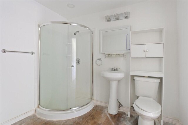 413 Houghton Ave, Marlin, TX 76661 - bathroom with a stall shower, toilet, and a sink