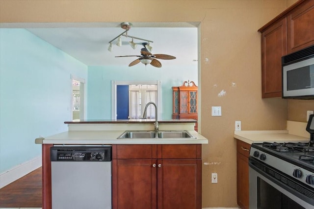 413 Houghton Ave, Marlin, TX 76661 - kitchen with stainless steel appliances, a sink, ceiling fan, light countertops, and dark wood-type flooring