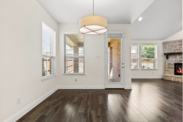 1514 Carnation St, Celina, TX 75078 - unfurnished dining area with a fireplace, dark wood finished floors, baseboards, and lofted ceiling