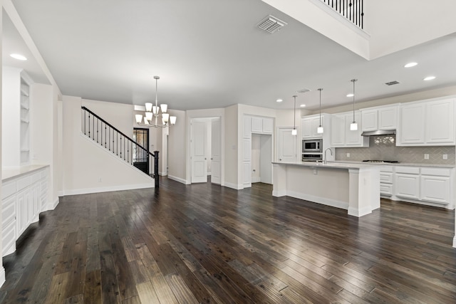 1514 Carnation St, Celina, TX 75078 - unfurnished living room with a chandelier, stairs, a sink, dark wood-style flooring, and recessed lighting