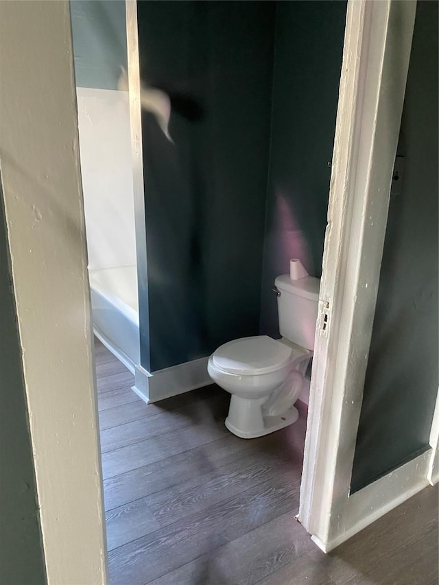 4122 Carver St, Shreveport, LA 71109 - full bathroom featuring wood finished floors, toilet, baseboards, and a shower