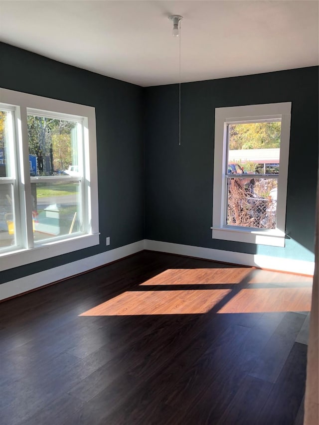 4122 Carver St, Shreveport, LA 71109 - empty room featuring dark wood-style flooring and healthy amount of natural light