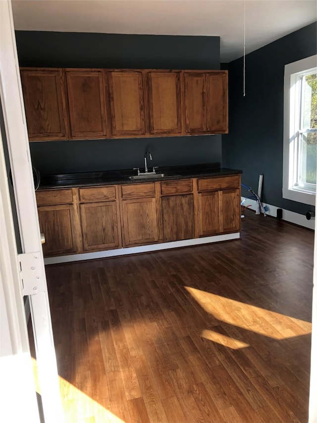 4122 Carver St, Shreveport, LA 71109 - kitchen featuring dark countertops, dark wood-type flooring, and a sink
