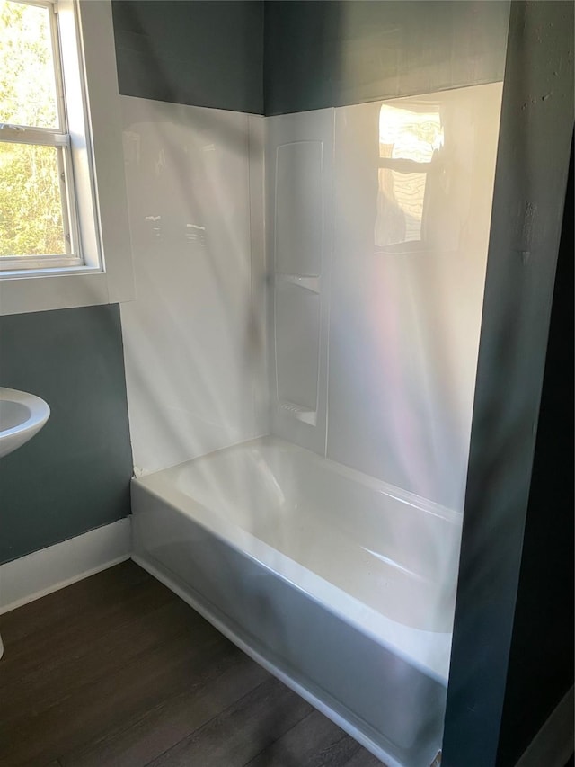 4122 Carver St, Shreveport, LA 71109 - full bath with wood finished floors, baseboards, and shower / tub combination