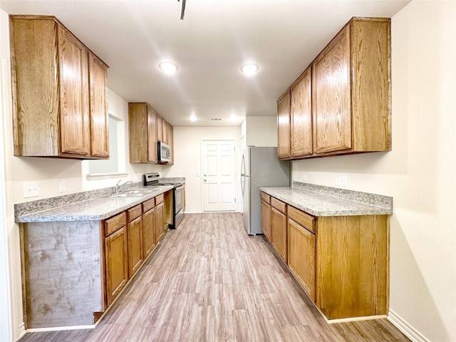 2422 Langston St, Fort Worth, TX 76105 - kitchen with appliances with stainless steel finishes, light wood-style floors, baseboards, brown cabinetry, and recessed lighting
