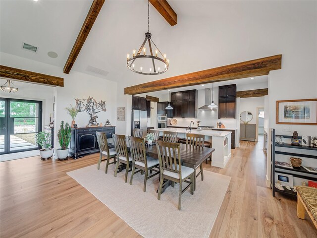 6362 Belz Rd, Sanger, TX 76266 - dining area featuring a chandelier, beam ceiling, light wood-style floors, and high vaulted ceiling