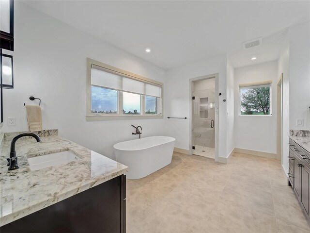 6362 Belz Rd, Sanger, TX 76266 - full bathroom featuring vanity, a shower stall, a freestanding tub, recessed lighting, and tile patterned floors
