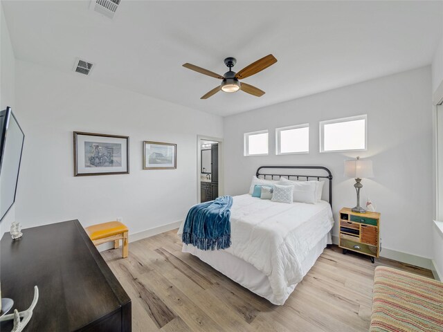 6362 Belz Rd, Sanger, TX 76266 - bedroom with light wood-style floors, baseboards, ensuite bath, and ceiling fan