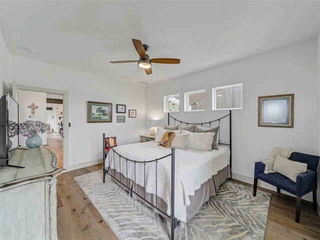 6362 Belz Rd, Sanger, TX 76266 - bedroom with wood finished floors, baseboards, and a ceiling fan