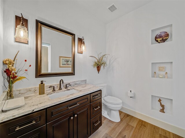 6362 Belz Rd, Sanger, TX 76266 - bathroom featuring wood finished floors, toilet, vanity, and baseboards