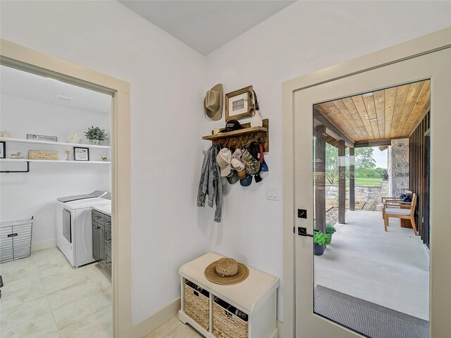 6362 Belz Rd, Sanger, TX 76266 - doorway to outside featuring washing machine and dryer, baseboards, and light marble finish floors