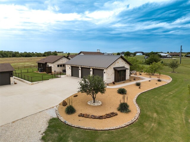 6362 Belz Rd, Sanger, TX 76266 - view of front of house featuring concrete driveway, metal roof, a standing seam roof, a garage, and stone siding