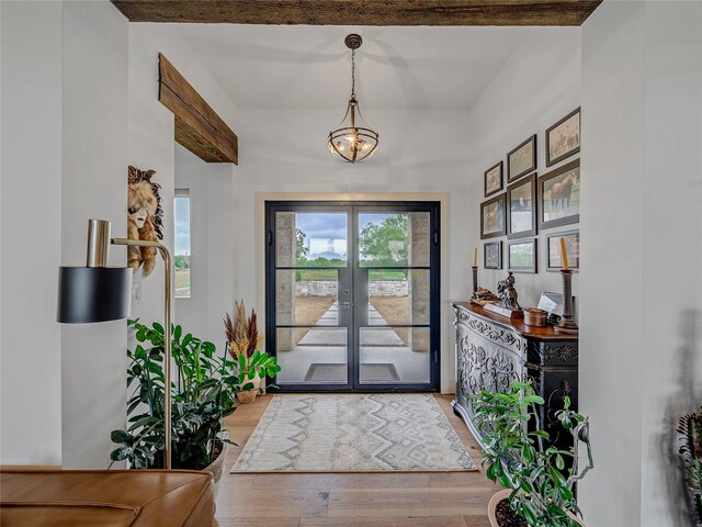 6362 Belz Rd, Sanger, TX 76266 - entrance foyer with wood finished floors, french doors, and a chandelier