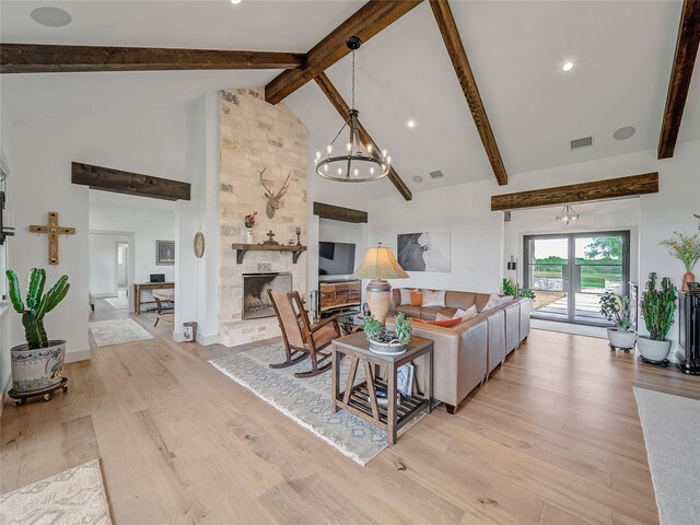 6362 Belz Rd, Sanger, TX 76266 - living room with light wood finished floors, beam ceiling, high vaulted ceiling, a chandelier, and a stone fireplace