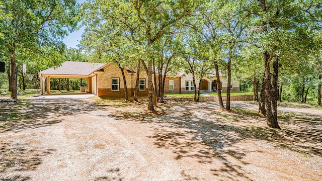 1851 Rock Church Hwy, Tolar, TX 76476 - view of front of home featuring stone siding, driveway, and a carport