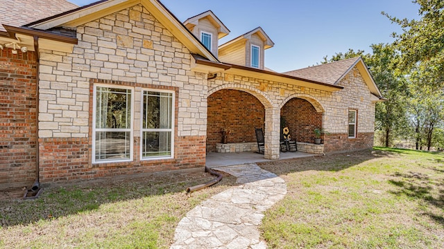 1851 Rock Church Hwy, Tolar, TX 76476 - view of front of property with a front yard, roof with shingles, brick siding, and stone siding