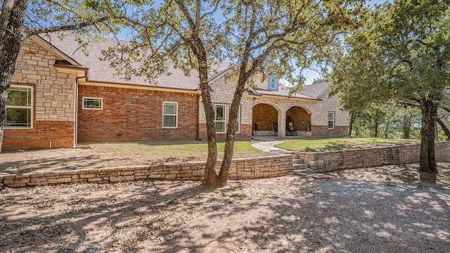 1851 Rock Church Hwy, Tolar, TX 76476 - view of front facade featuring a patio area, a shingled roof, and brick siding