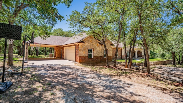 1851 Rock Church Hwy, Tolar, TX 76476 - view of front of property with an attached garage, driveway, stone siding, brick siding, and a carport