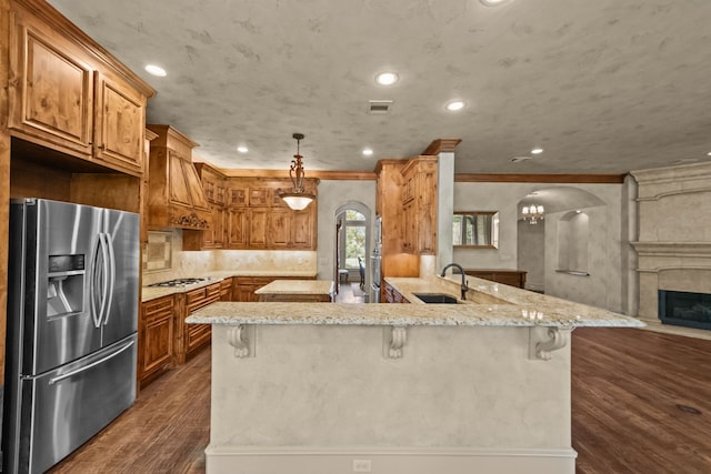 608 Guadalupe Rd, Keller, TX 76248 - kitchen featuring stainless steel refrigerator with ice dispenser, white gas stovetop, dark wood finished floors, arched walkways, and recessed lighting