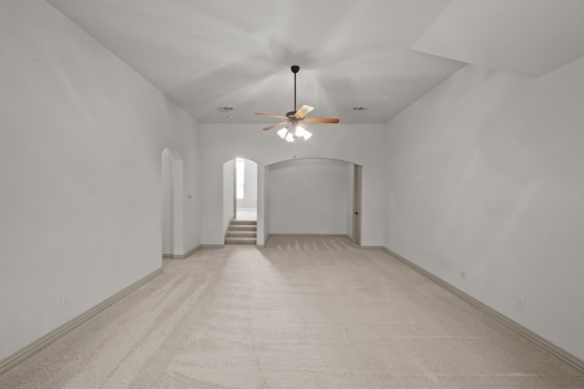 608 Guadalupe Rd, Keller, TX 76248 - unfurnished room with arched walkways, ceiling fan, light carpet, stairway, and baseboards