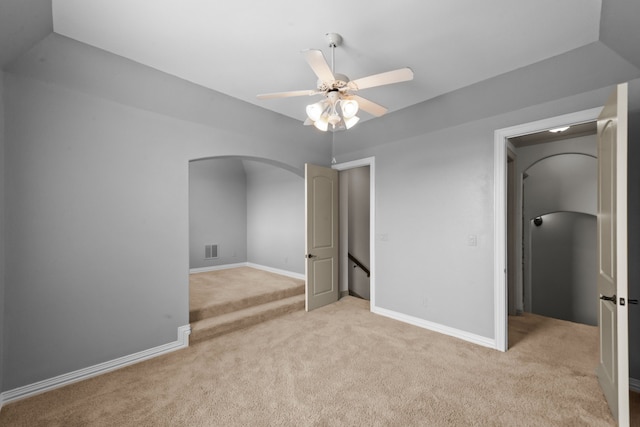 608 Guadalupe Rd, Keller, TX 76248 - spare room featuring light carpet, arched walkways, ceiling fan, and baseboards