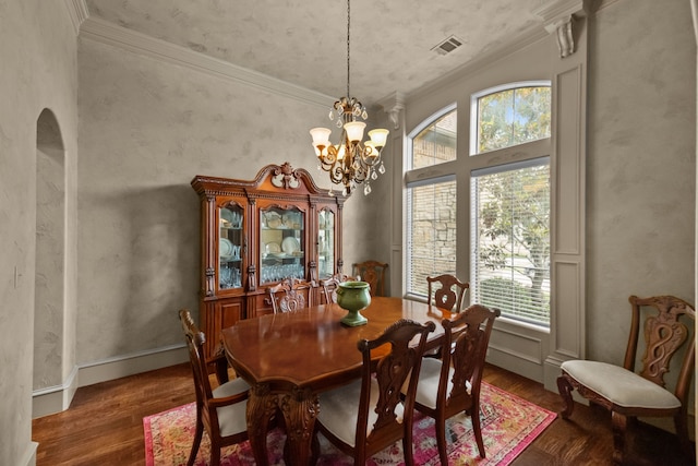 608 Guadalupe Rd, Keller, TX 76248 - dining room with wood finished floors, a chandelier, crown molding, and arched walkways