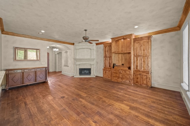 608 Guadalupe Rd, Keller, TX 76248 - unfurnished living room featuring ceiling fan, ornamental molding, dark wood-type flooring, baseboards, and a chandelier