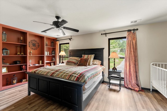 7016 Fm 3054, Malakoff, TX 75148 - bedroom with wood finished floors, radiator, and a ceiling fan