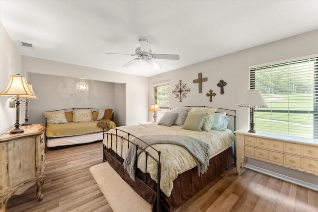 7016 Fm 3054, Malakoff, TX 75148 - bedroom featuring light wood-type flooring, a chandelier, and a ceiling fan