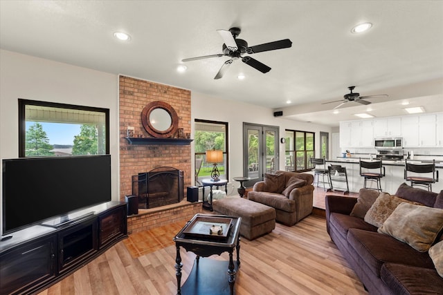7016 Fm 3054, Malakoff, TX 75148 - living room featuring ceiling fan, light wood-type flooring, a fireplace, and recessed lighting