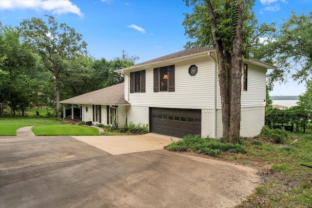 7016 Fm 3054, Malakoff, TX 75148 - view of front of home with a garage, driveway, brick siding, and a front yard