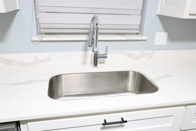 494 Lannius Rd, Dodd City, TX 75438 - kitchen view of a sink, white cabinetry, and light stone counters